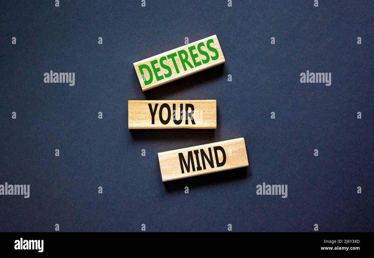 Destress your mind symbol. Concept words Destress your mind on wooden blocks. Beautiful black table black background. Psychological business and destr Stock Photo