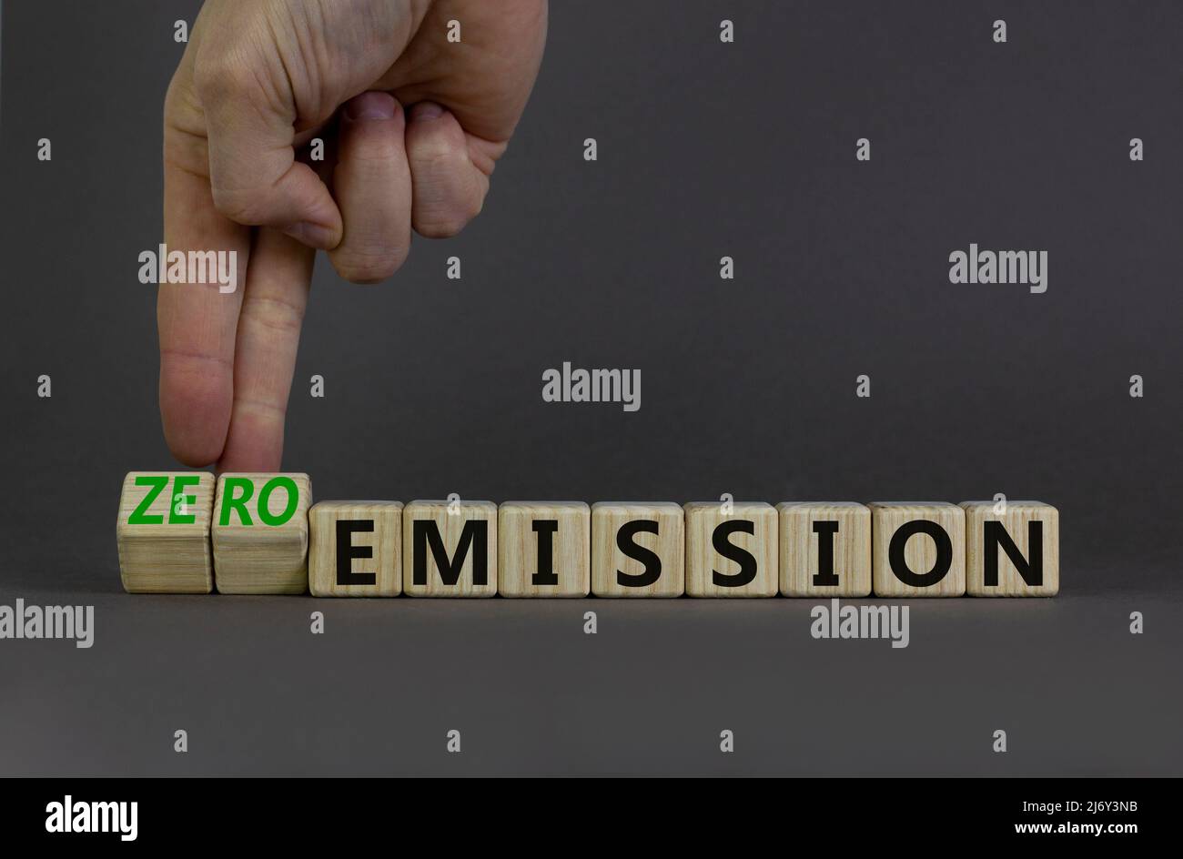 Zero emission symbol. Businessman turns wooden cubes and changes words