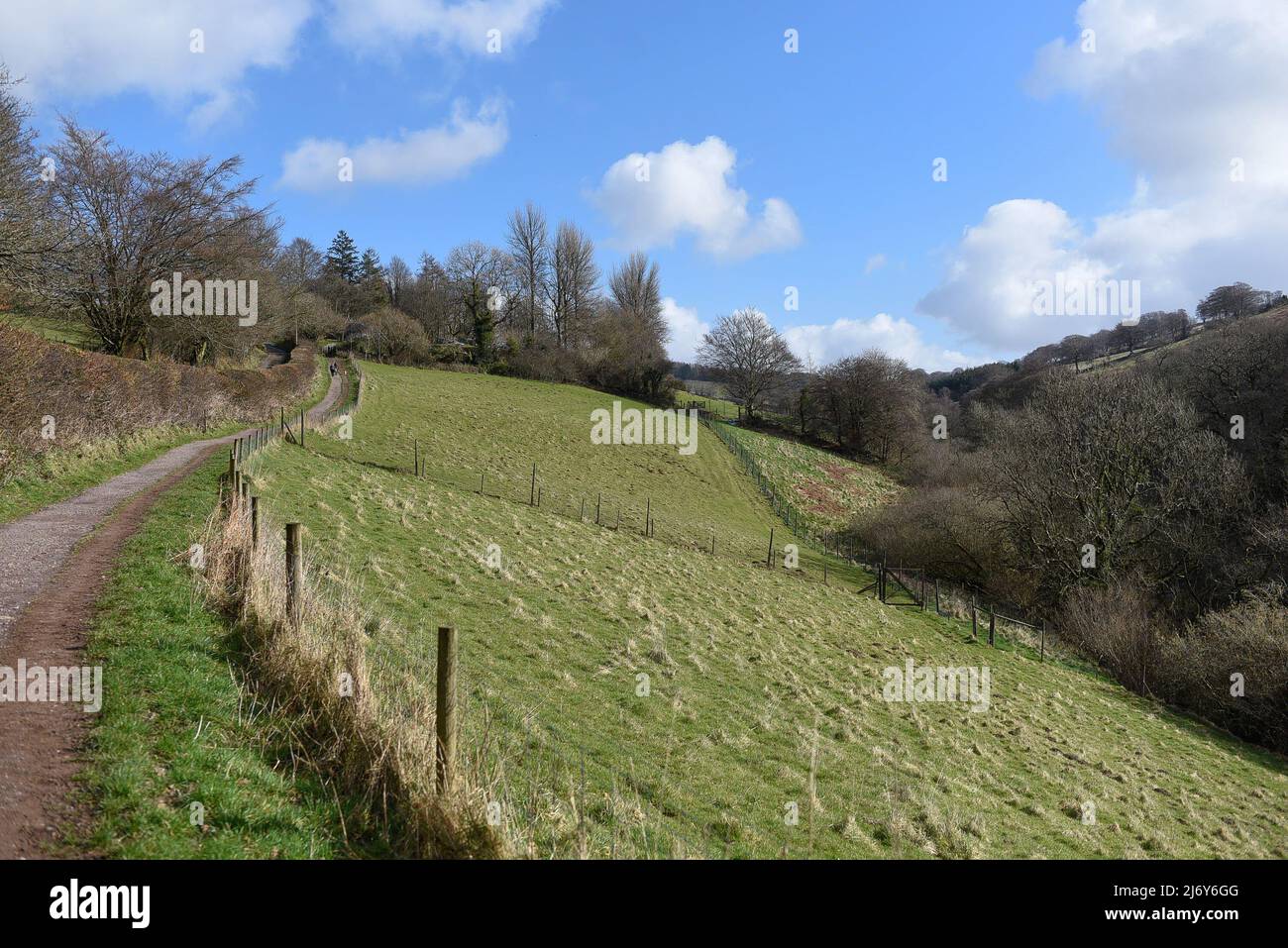 Country walks in Devon open gate to field on hill climb on summer day Stock Photo
