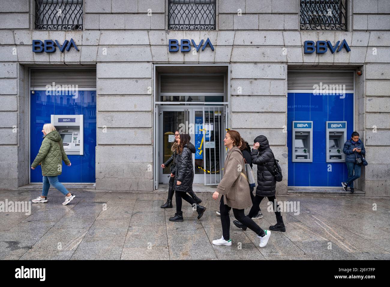 Pedestrians walk past the Spanish multinational Banco Bilbao Vizcaya Argentaria SA (BBVA) bank in Spain. Stock Photo