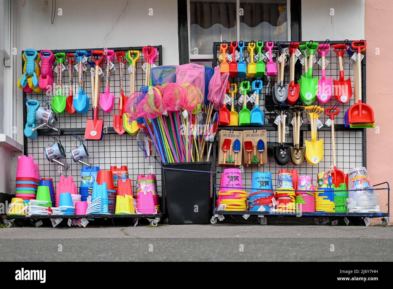 bucket and spades for sale traditional seaside shop selling beach toys. Stock Photo