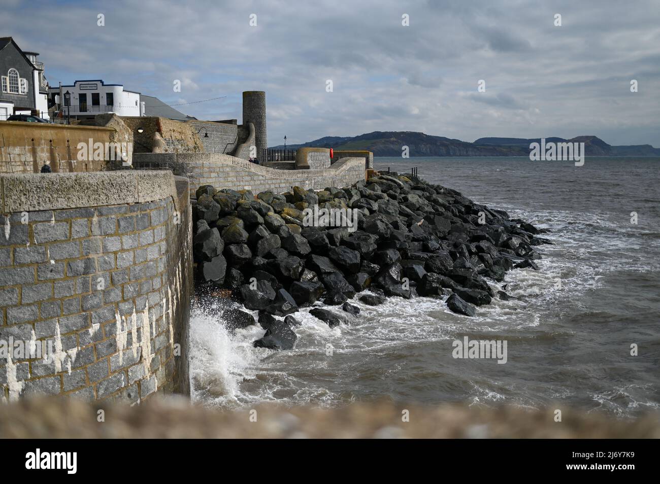 Lyme Regis sea defence rocks to protect shore line Stock Photo