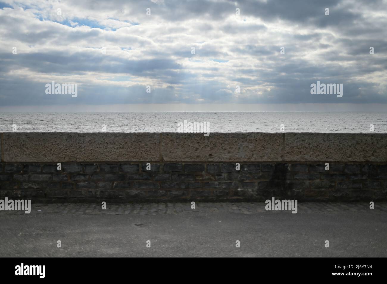 Lyme Regis beach wall looking out to sea. Stock Photo