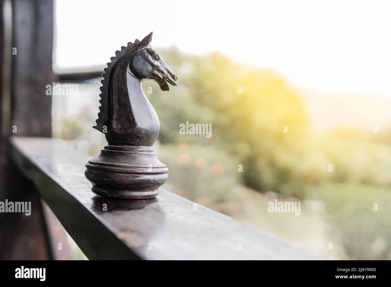 Horse giant chess piece on the wooden balcony of a country house or farm in a rural area Stock Photo