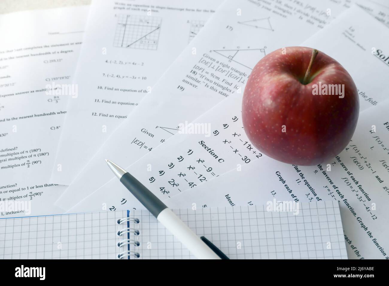 Handwriting of mathematics quadratic equation on examination, practice, quiz or test in maths class. Solving exponential equations background concept. Stock Photo