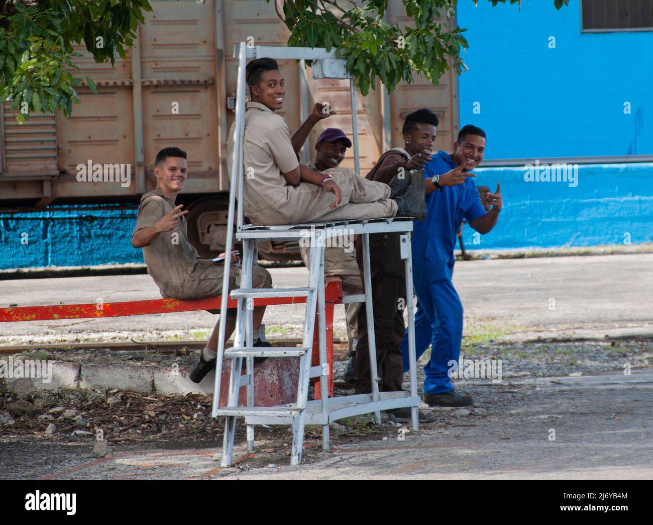 Young security office co-workers laugh together while taking a break working in Havana, Cuba. Stock Photo