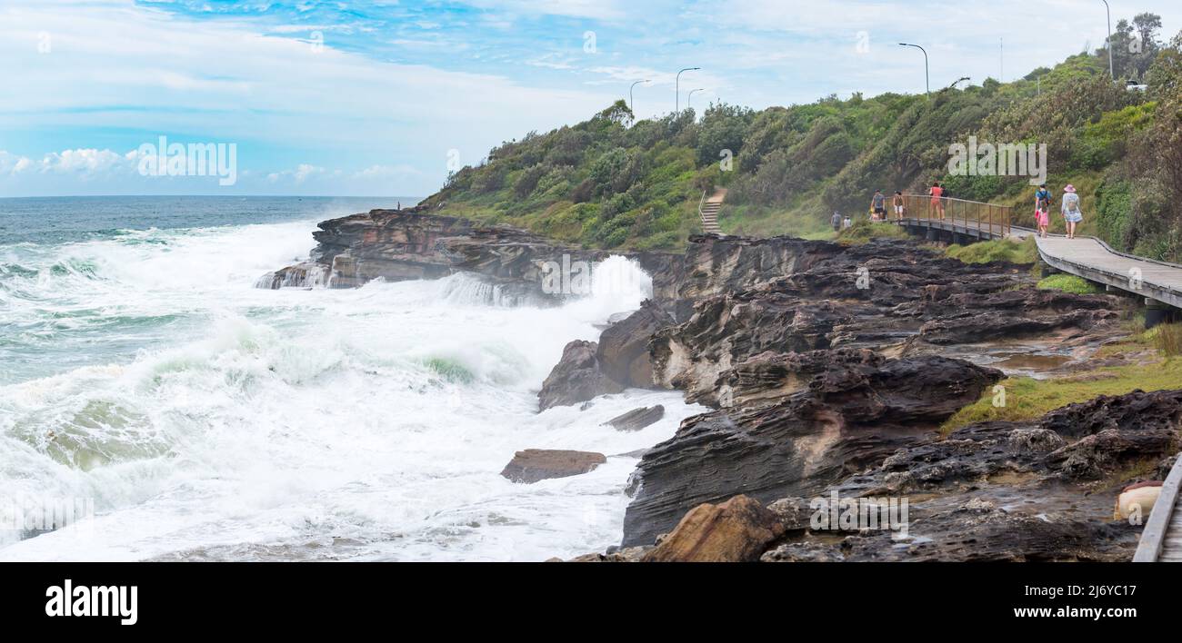 Big seas, due to an East Coast Low, (low pressure system) pound the rocky coastline and the Curl Curl (Beach) Boardwalk in Sydney, NSW, Australia Stock Photo