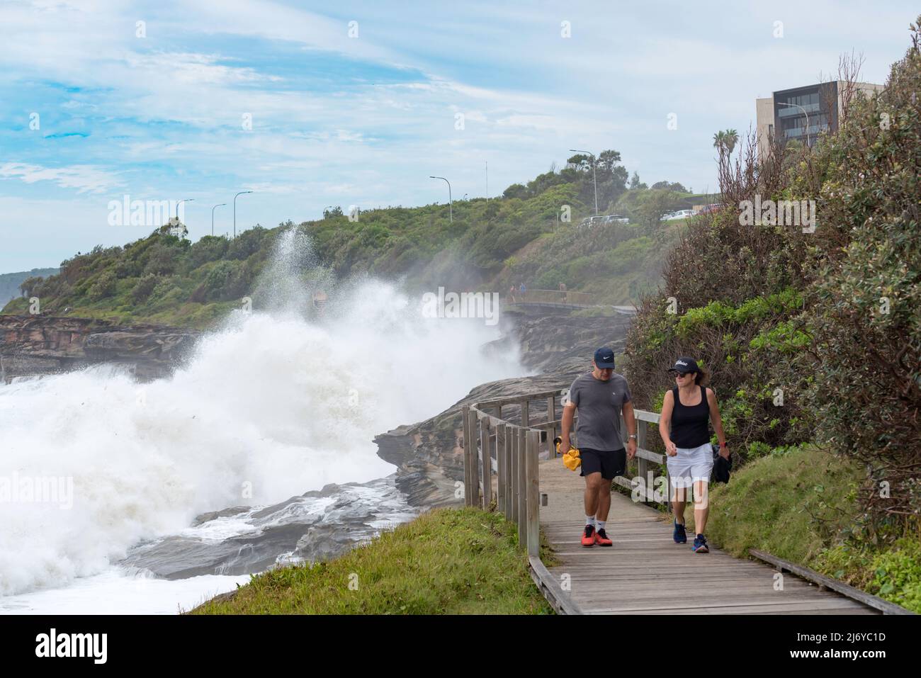 Big seas, due to an East Coast Low, (low pressure system) pound the rocky coastline and the Curl Curl (Beach) Boardwalk in Sydney, NSW, Australia Stock Photo