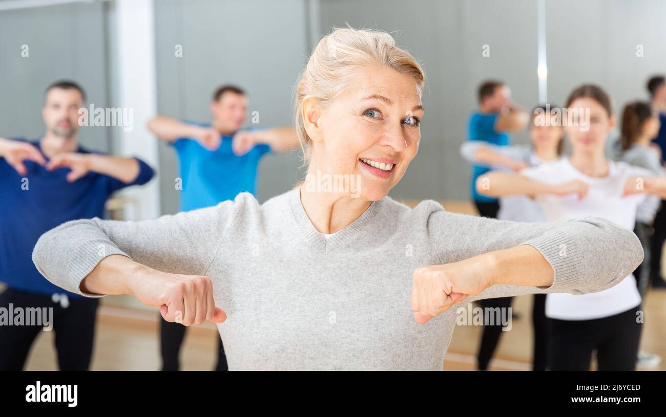 Mature woman practicing vigorous dance Stock Photo