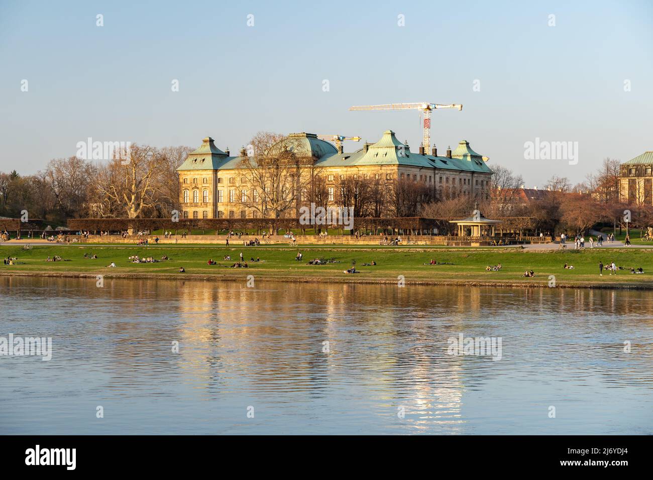 Japanese palace museum on the other side if the elbe river on a sunny springtime day. The sunset light is shining on the historic building exterior. Stock Photo