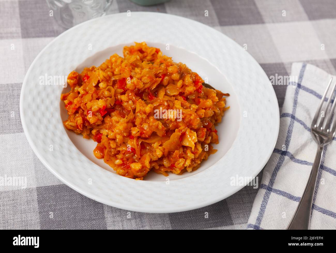 Braised white cabbage with pearl barley, carrot and onion Stock Photo