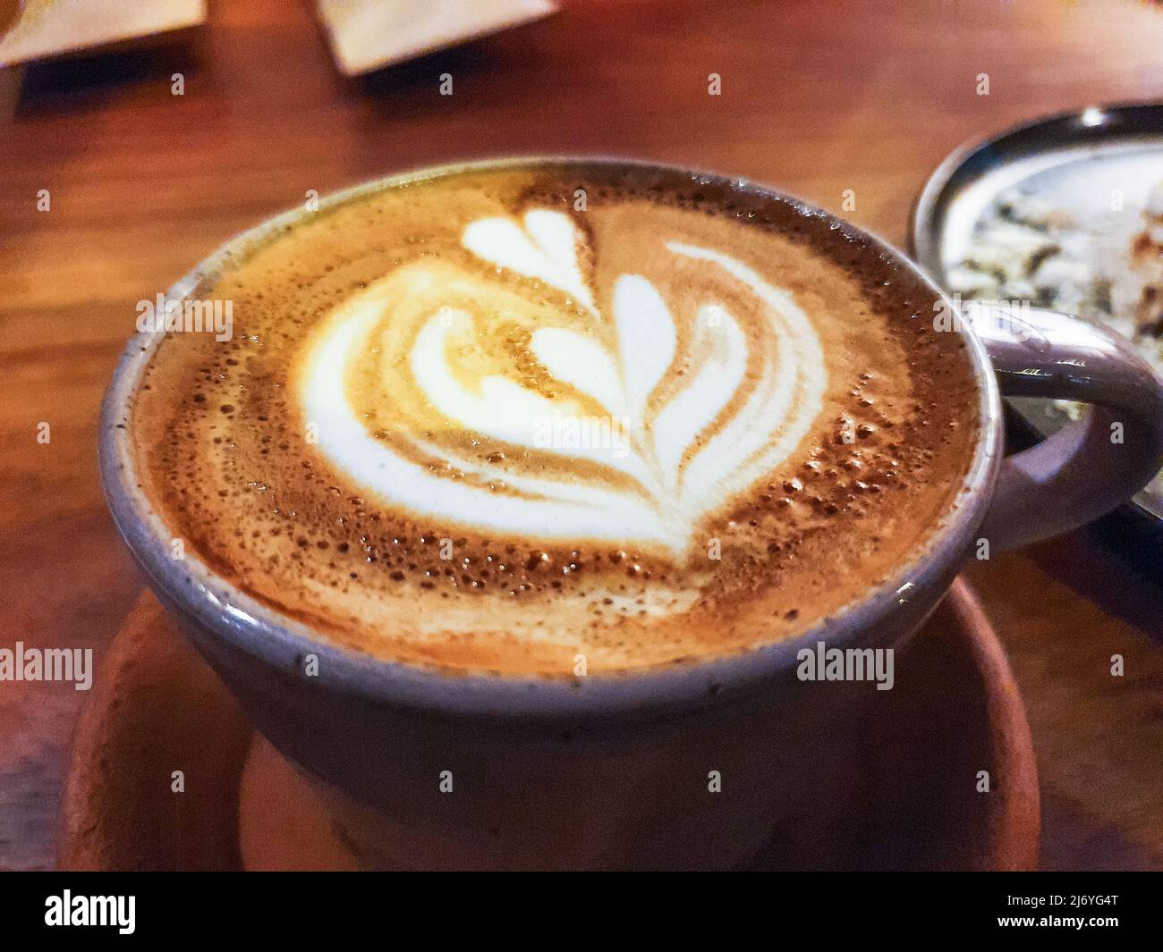 Cup of cappuccino coffee on wooden table Stock Photo