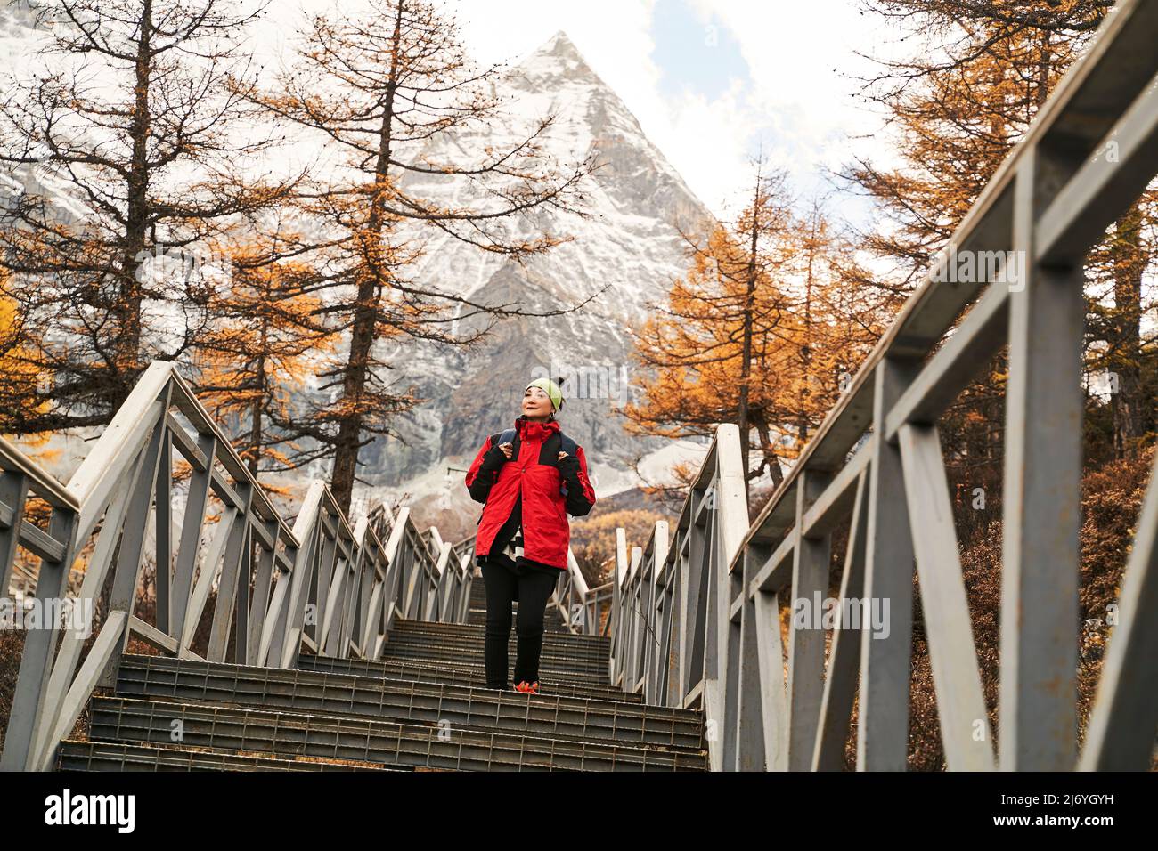asian woman female tourist walking on steps at the foot of mount chenrezig in yading national park in daocheng county, sichuan province, china Stock Photo