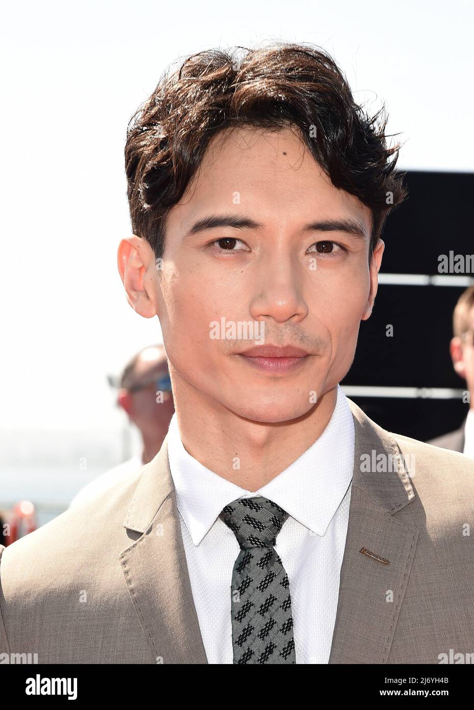 Manny Jacinto walking on the red carpet at the global premiere of "Top