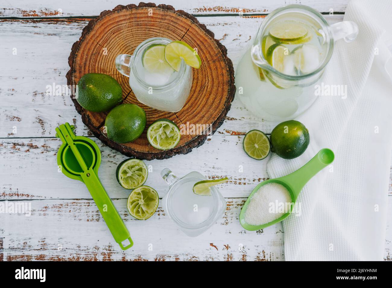 Jar glass of lemonade drink with green lemons or lime on a white background in Latin America Stock Photo