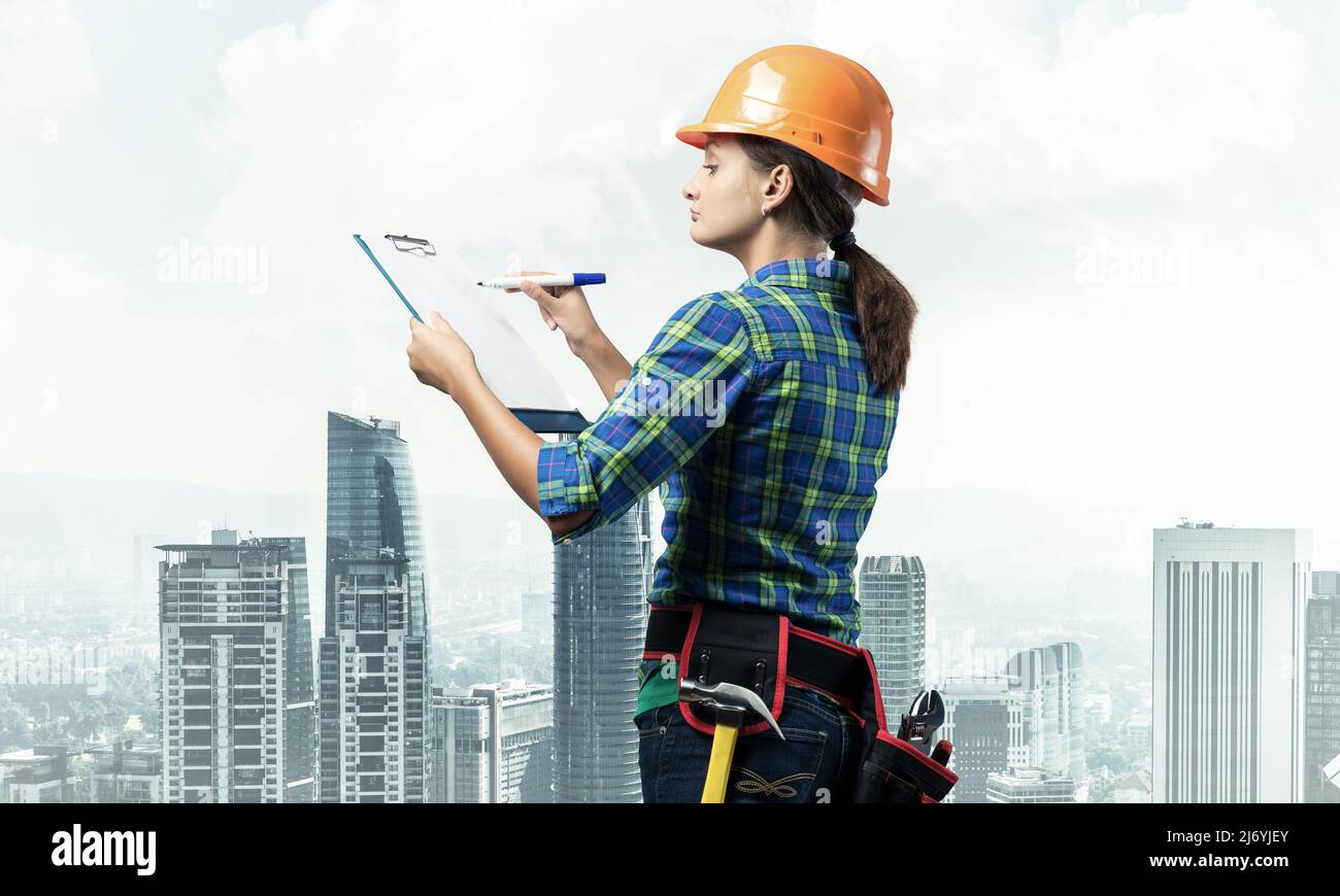 Young building controller with clipboard Stock Photo - Alamy