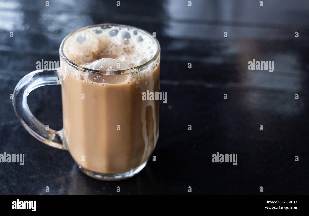 Teh Tarik, is infused black tea with milk served in thick froth. Popular drinks in Malaysia Stock Photo