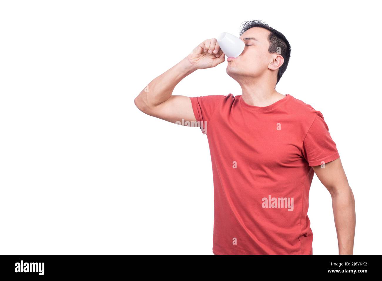 Guy drinking coffee from cup on white background Stock Photo