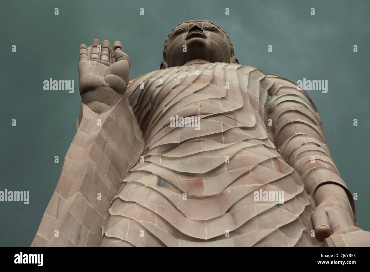 A 80-feet-high sandstone statue of Standing Buddha in Sarnath on the outskirts of Varanasi, Uttar Pradesh, India. Constructed from 1997 to 2011, the statue was a result of a joint effort between Thailand and India. Stock Photo