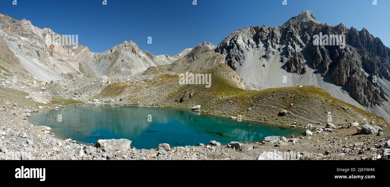 Beautiful small lake in the mountains above Ubaye valley in french alps - Lac bleu Stock Photo