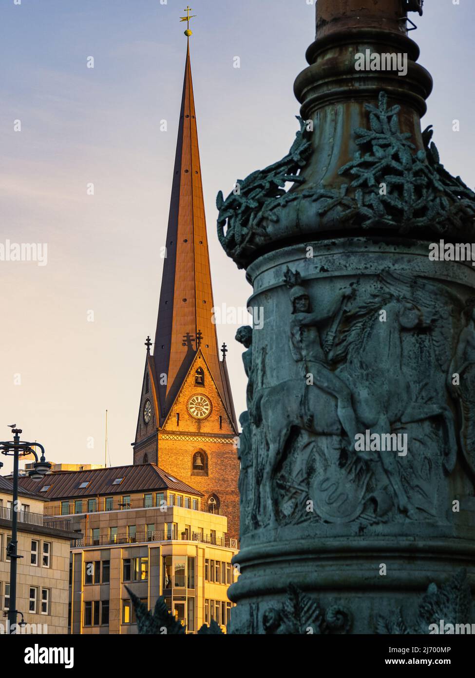 vertical photography with view from hamburg town square to the roof of the clock tower of st. peter's church during dusk. Stock Photo