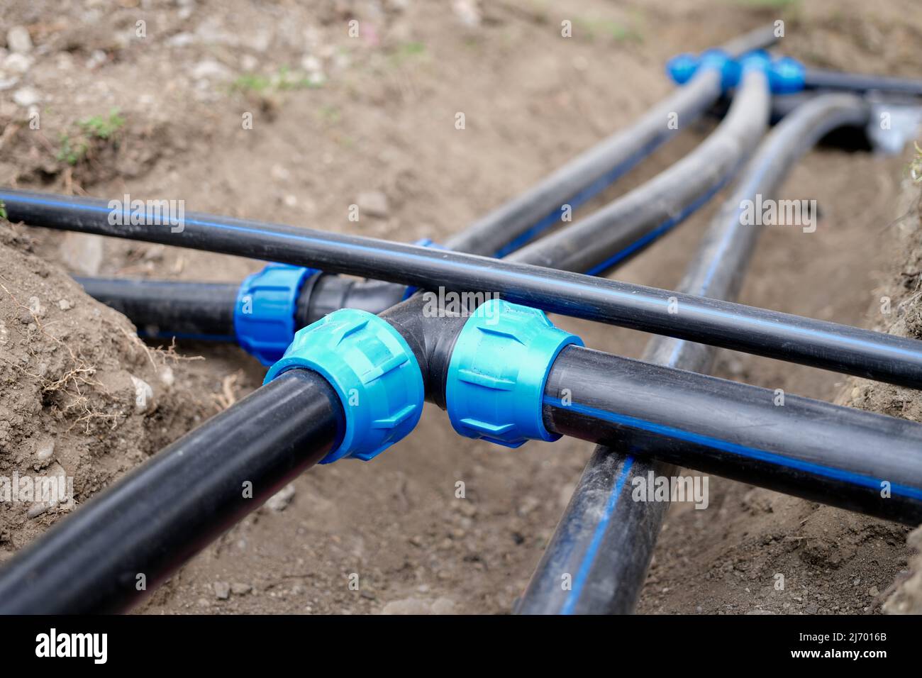 Connection of plastic sewer pipes closeup. Irrigation system for vegetable garden concept Stock Photo