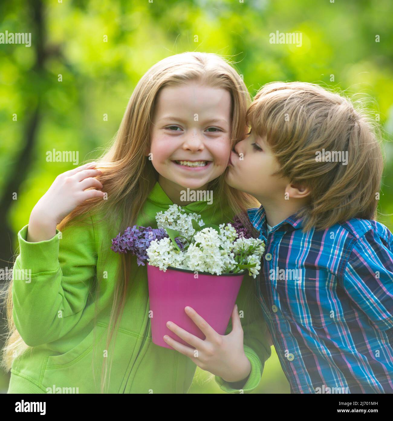 Two little children hug and kiss each other in summer garden. Kids couple  in love. Friendship and childhood. Little girl kissing little boy outdoors  Stock Photo - Alamy