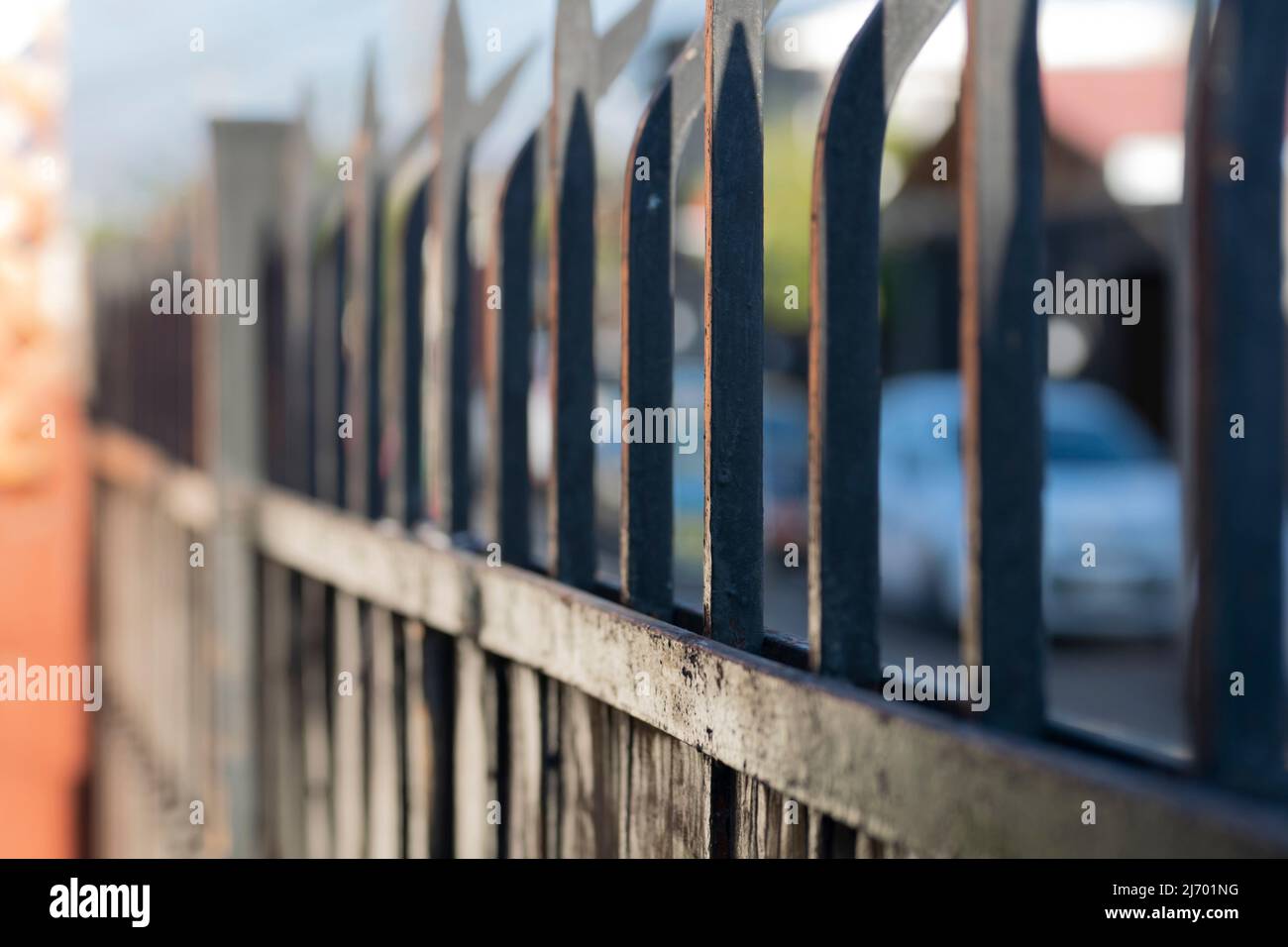 iron spikes of a security fence. gate of a house with its iron spikes to prevent theft Stock Photo