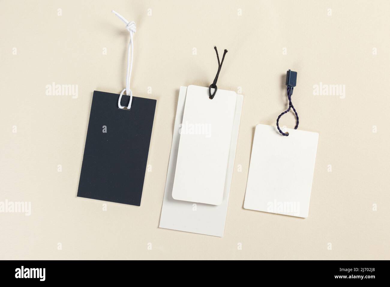 Clothing tag, label blank mockup template on a beige background place