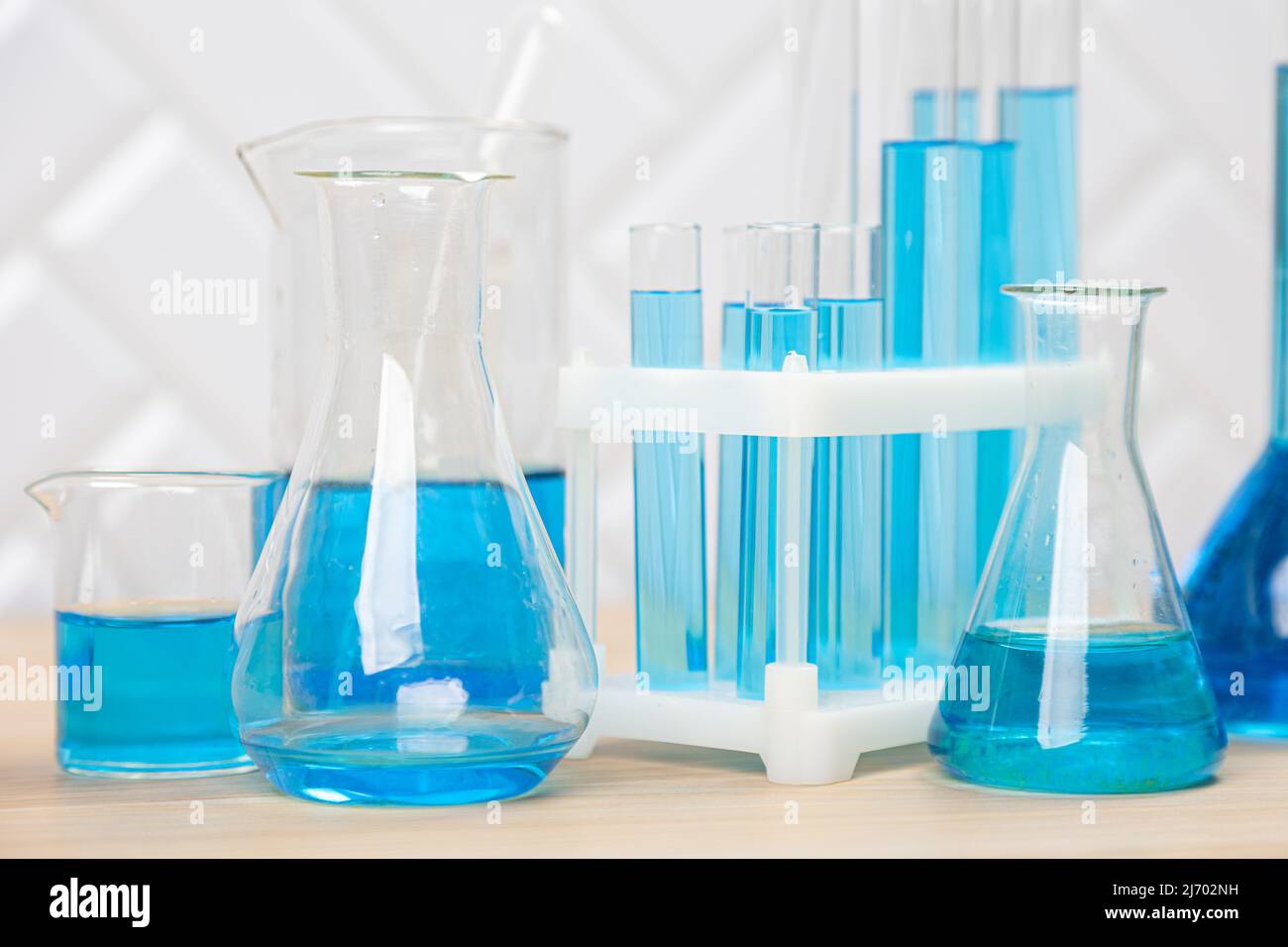 Laboratory glassware with blue liquid in a test tube. scientific ...