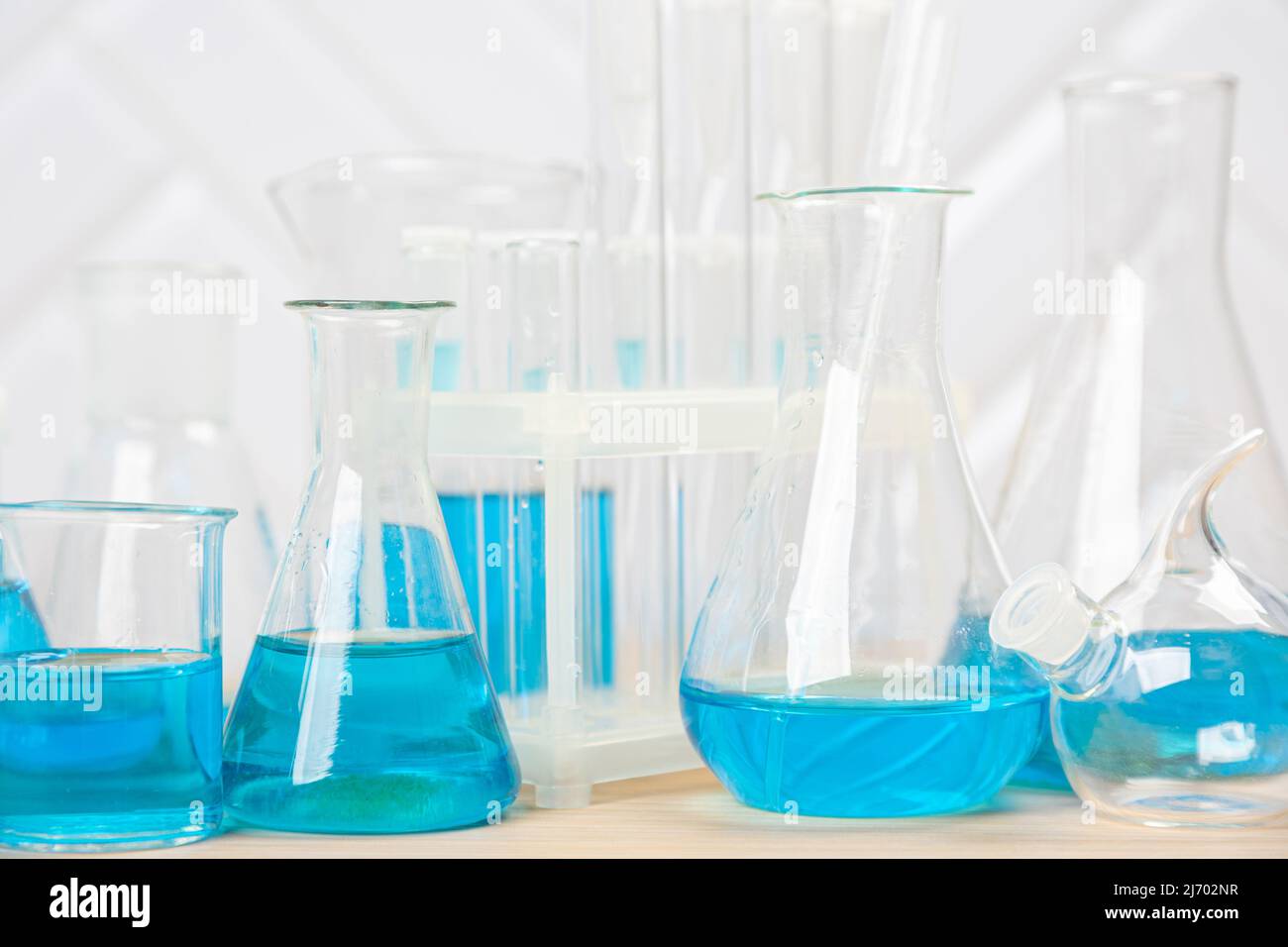 Laboratory glassware with blue liquid in a test tube. scientific ...