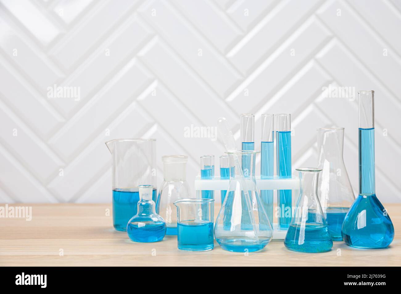 Laboratory glassware with blue liquid in a test tube. scientific ...