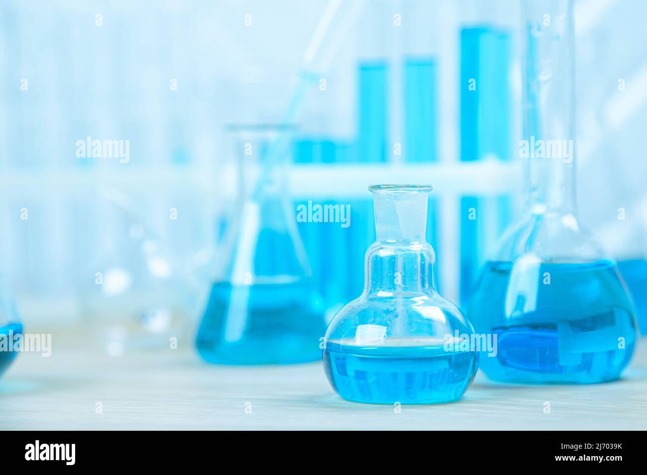 Laboratory glassware with blue liquid in a test tube. scientific ...