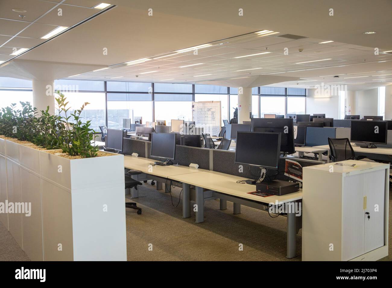 Open plan corporate business offices deserted during Covid 19 with workers directed to work from home,Sydney,NSW,Australia Stock Photo