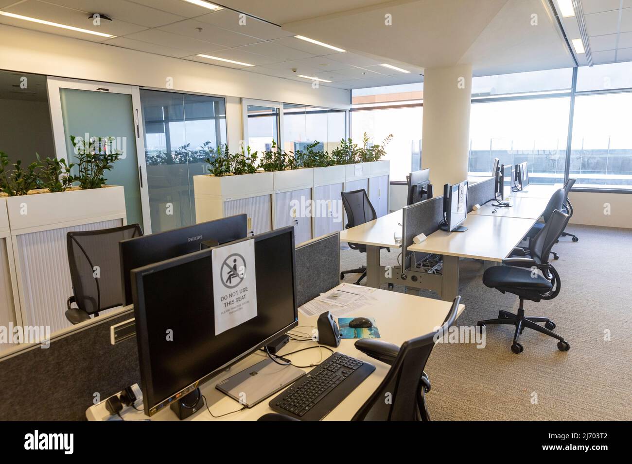 Open plan corporate business offices deserted during Covid 19 with workers directed to work from home,Sydney,NSW,Australia Stock Photo