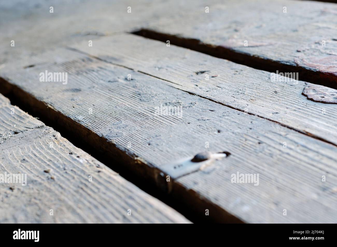 A defocused shot of the old floorboards. Dirty rectangular repeating