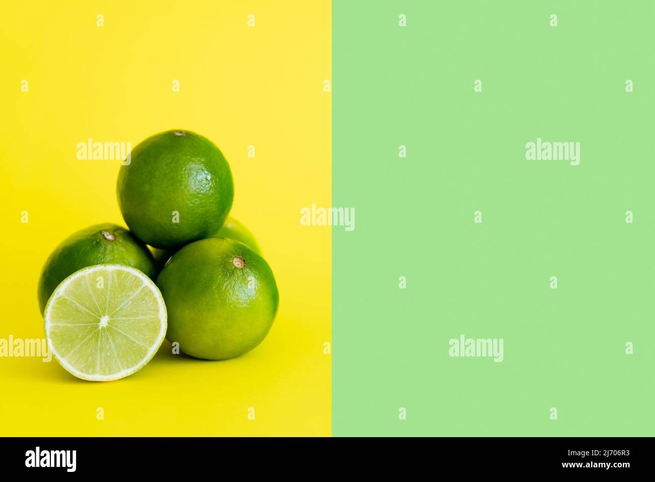 Juicy limes on yellow and green background with copy space Stock Photo ...