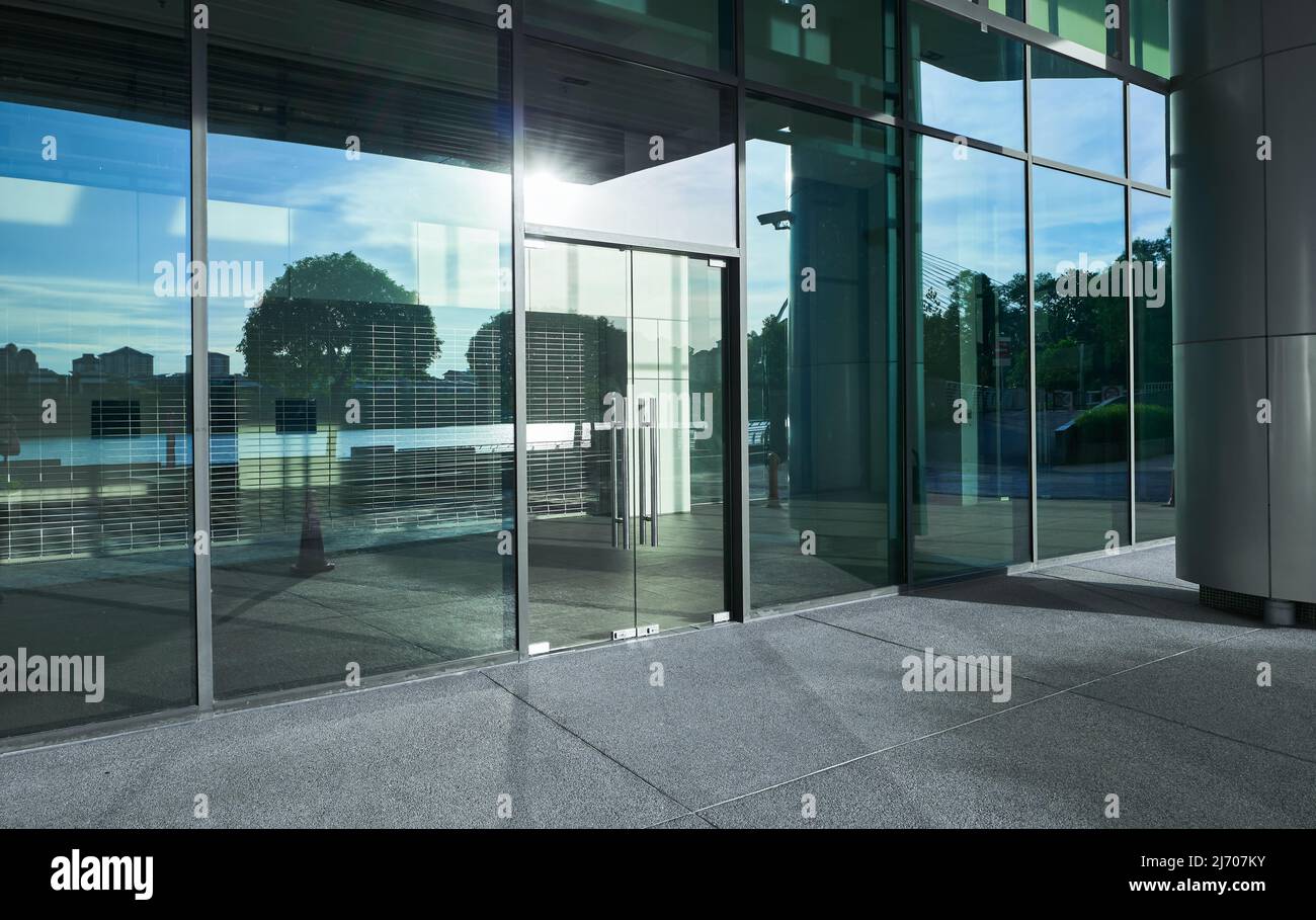 Empty ground in front of modern glass wall facade buildings . Stock Photo