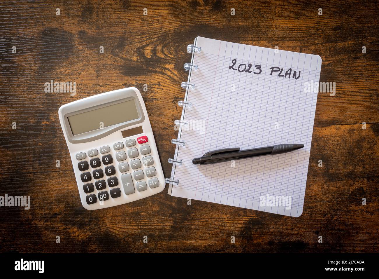 calculator and notepad with text 2023 Plan on wooden table Stock Photo