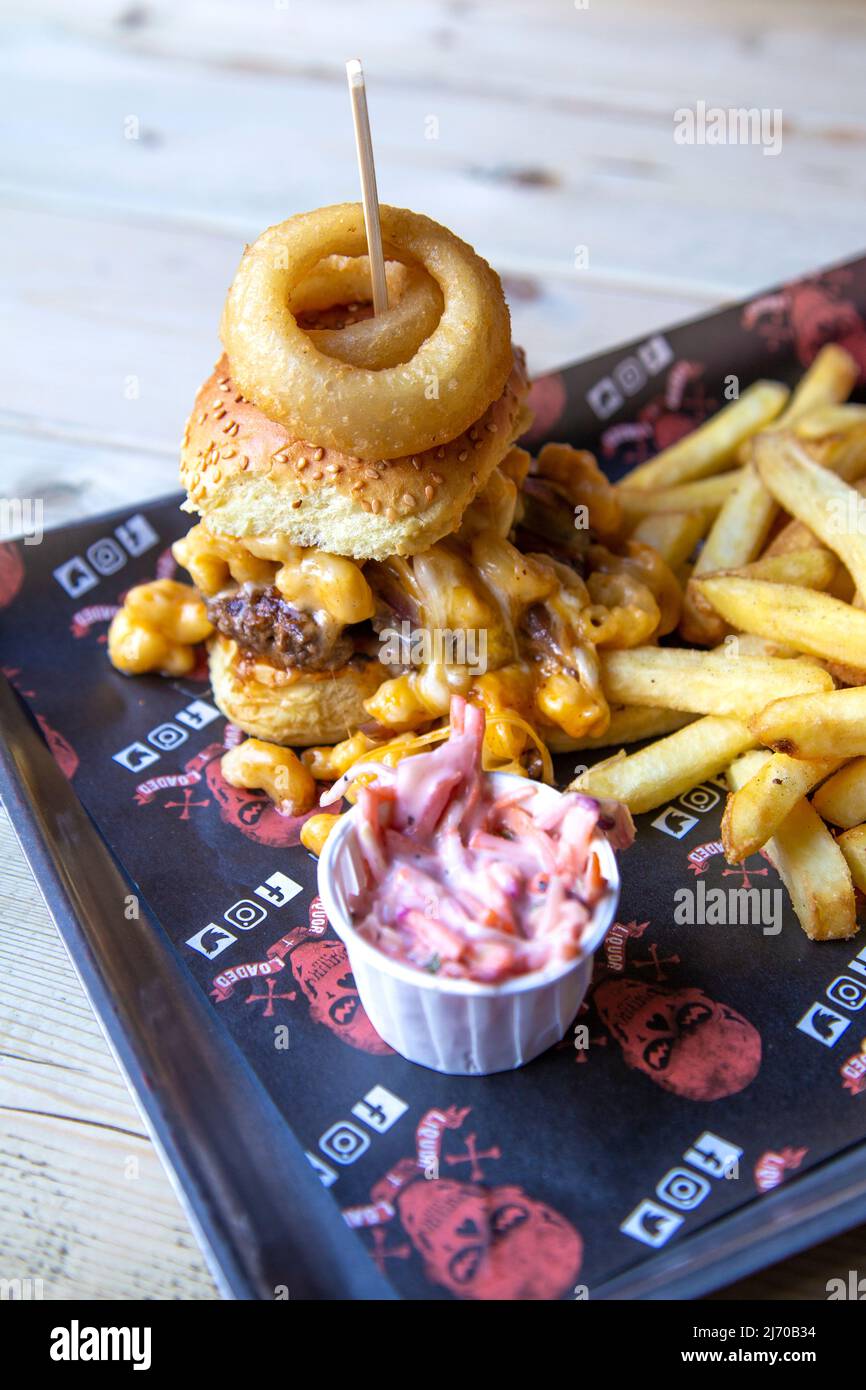 Mac Attack Burger topped with mac and cheese with fries at Liquor & Loaded, King's Lynn, Norfolk, UK Stock Photo