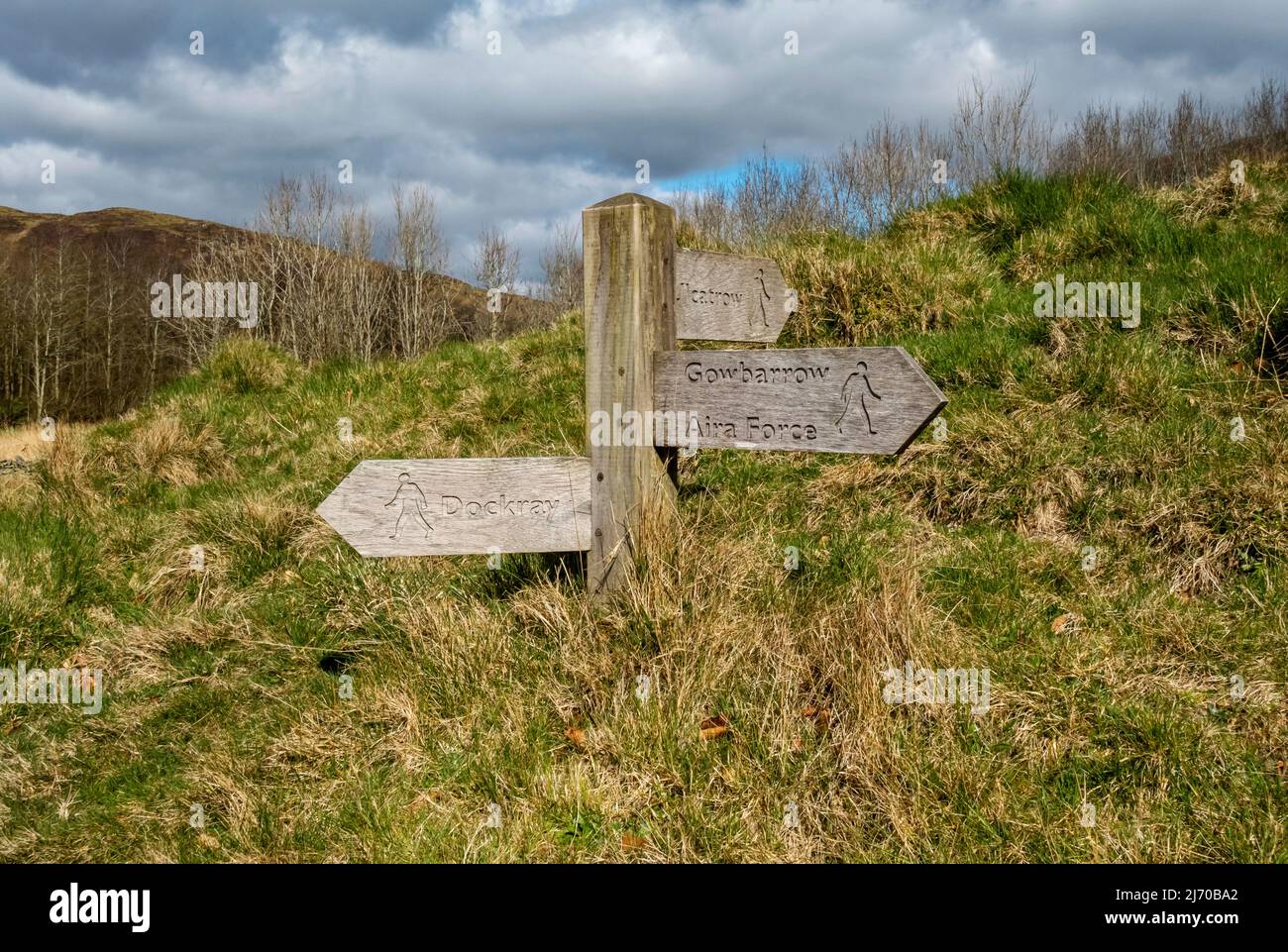 Close up of wooden public footpath sign signpost to Aira Force near Ullswater in spring Lake District National Park Cumbria England UK  GB Stock Photo