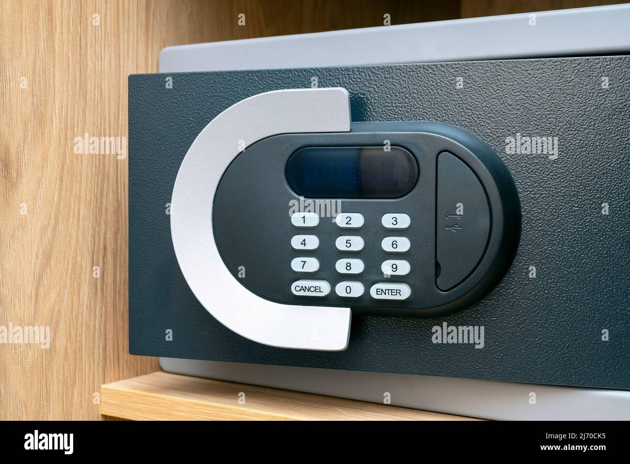 Close-up of code lock on opened iron safe door at hotel room Stock Photo