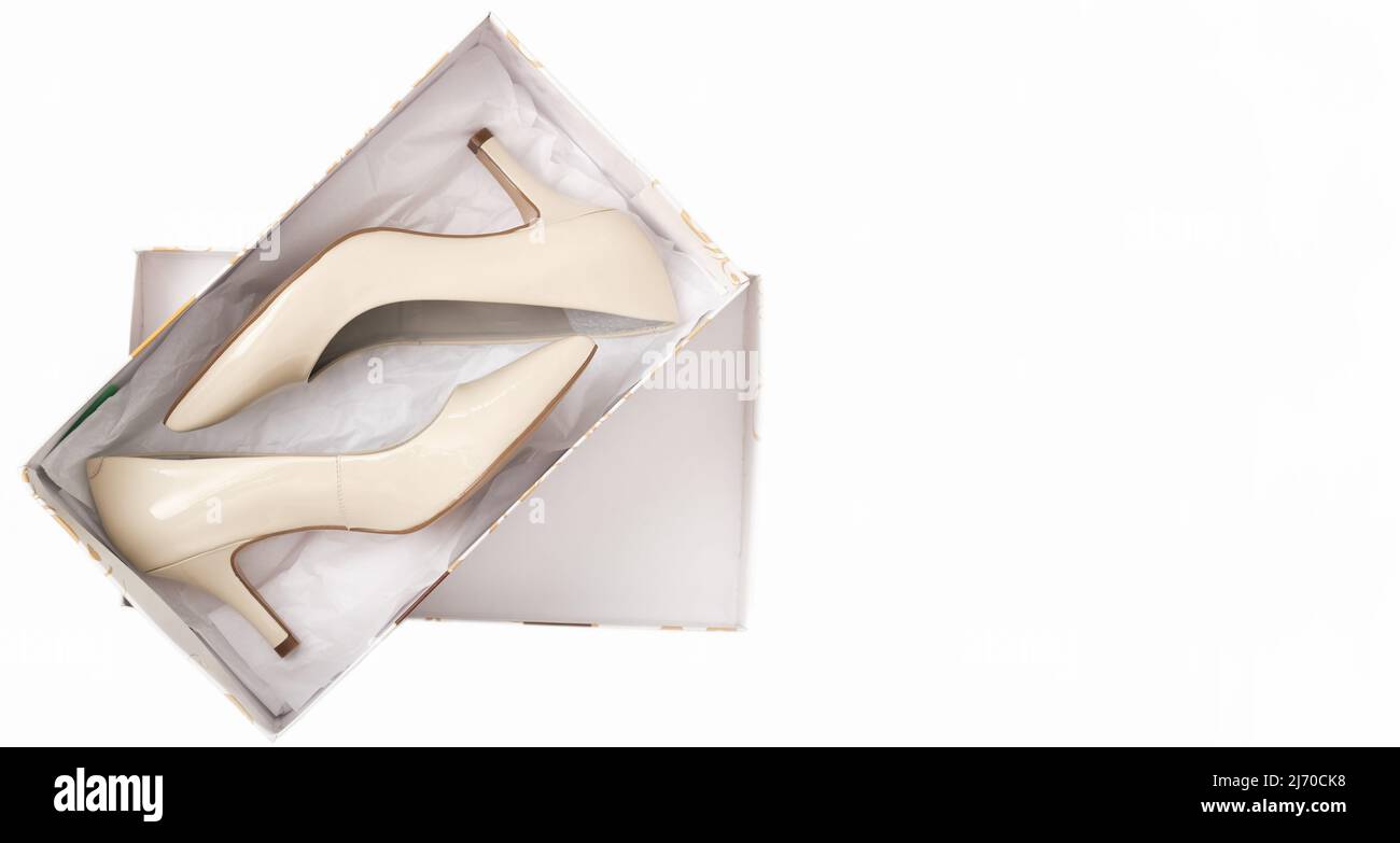 new pair of classic beige heel shoes in a box. shopping, retail and footwear concept, banner. Stock Photo