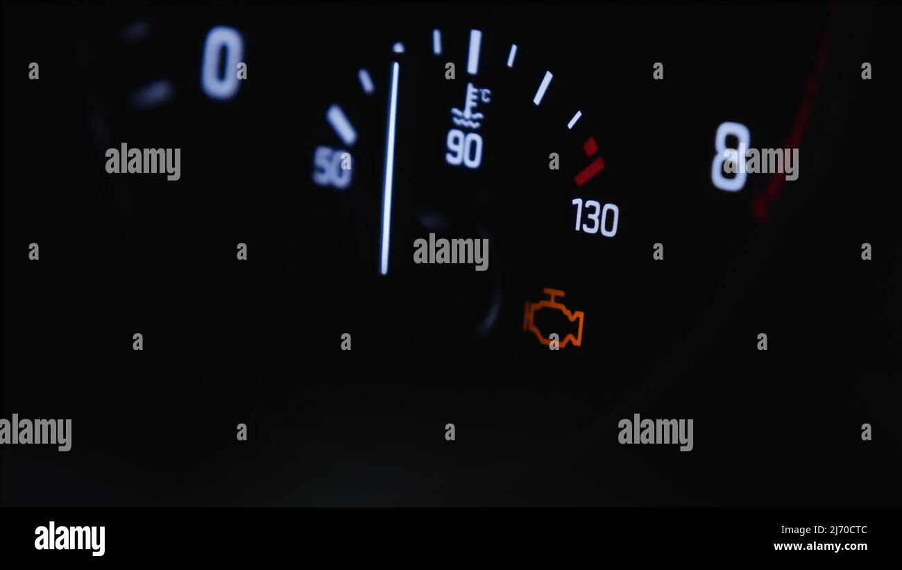 Real car temperature gauge. White gauges over black background. Check