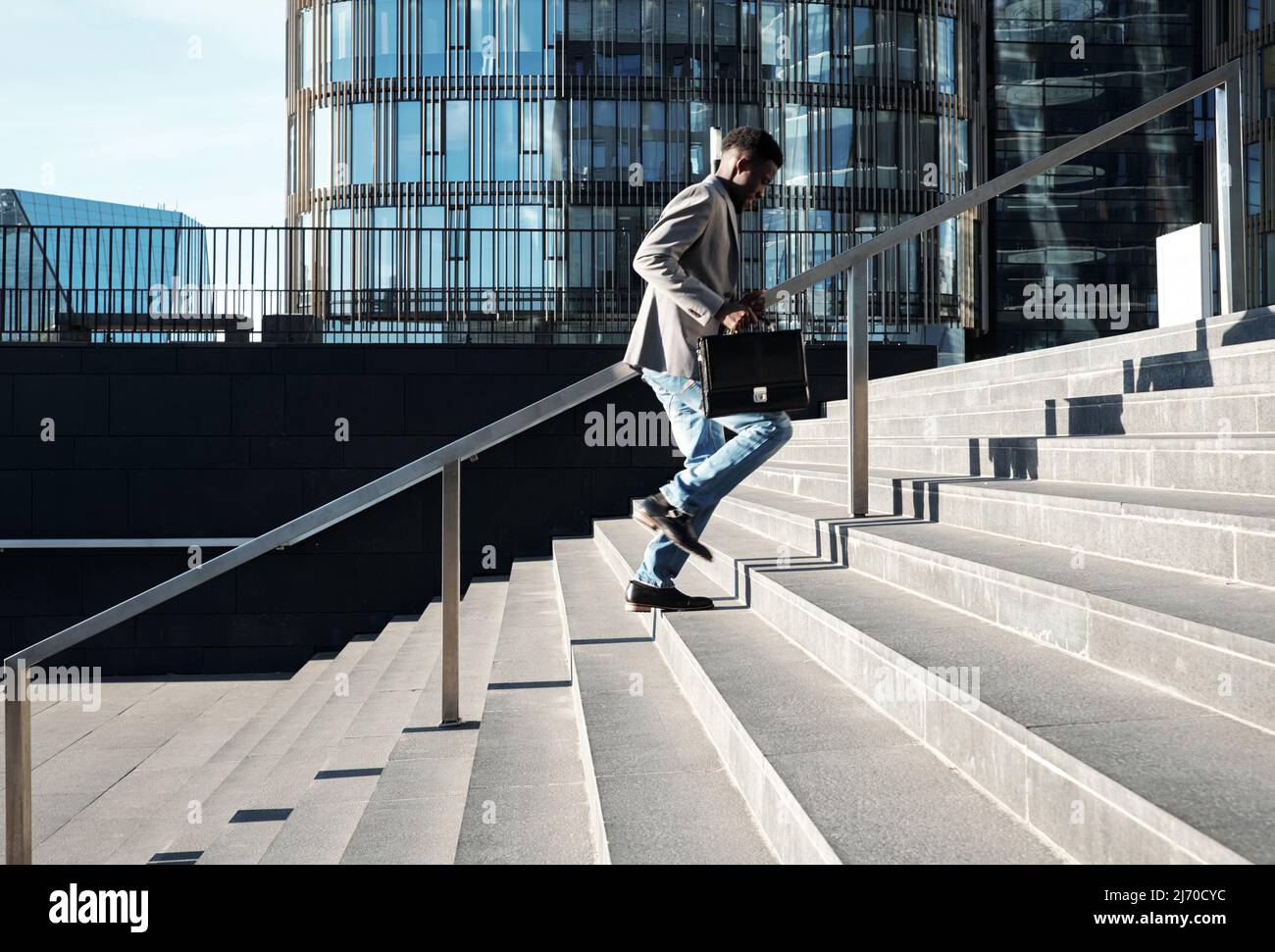 Black man running up stairs hi-res stock photography and images - Alamy