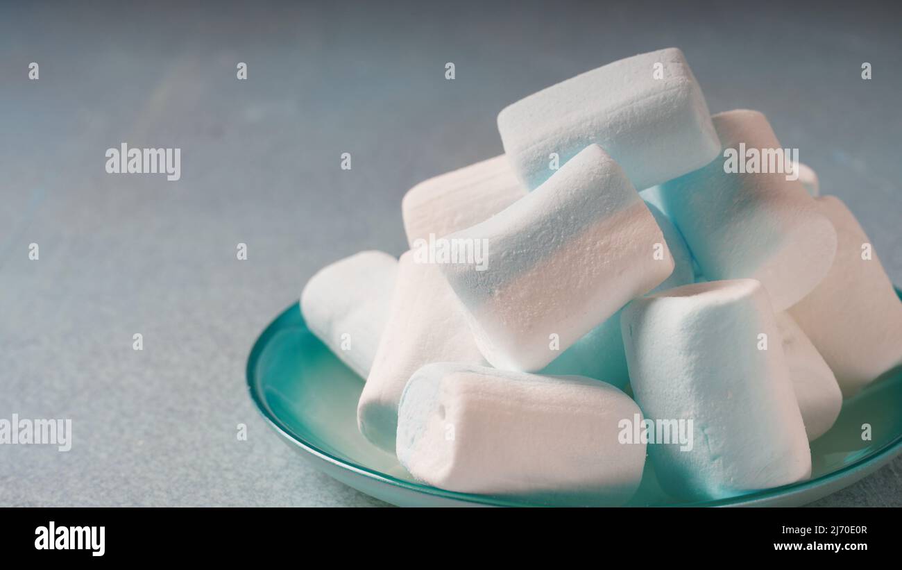 Pink ,white and blue marshmallows on a plate Stock Photo