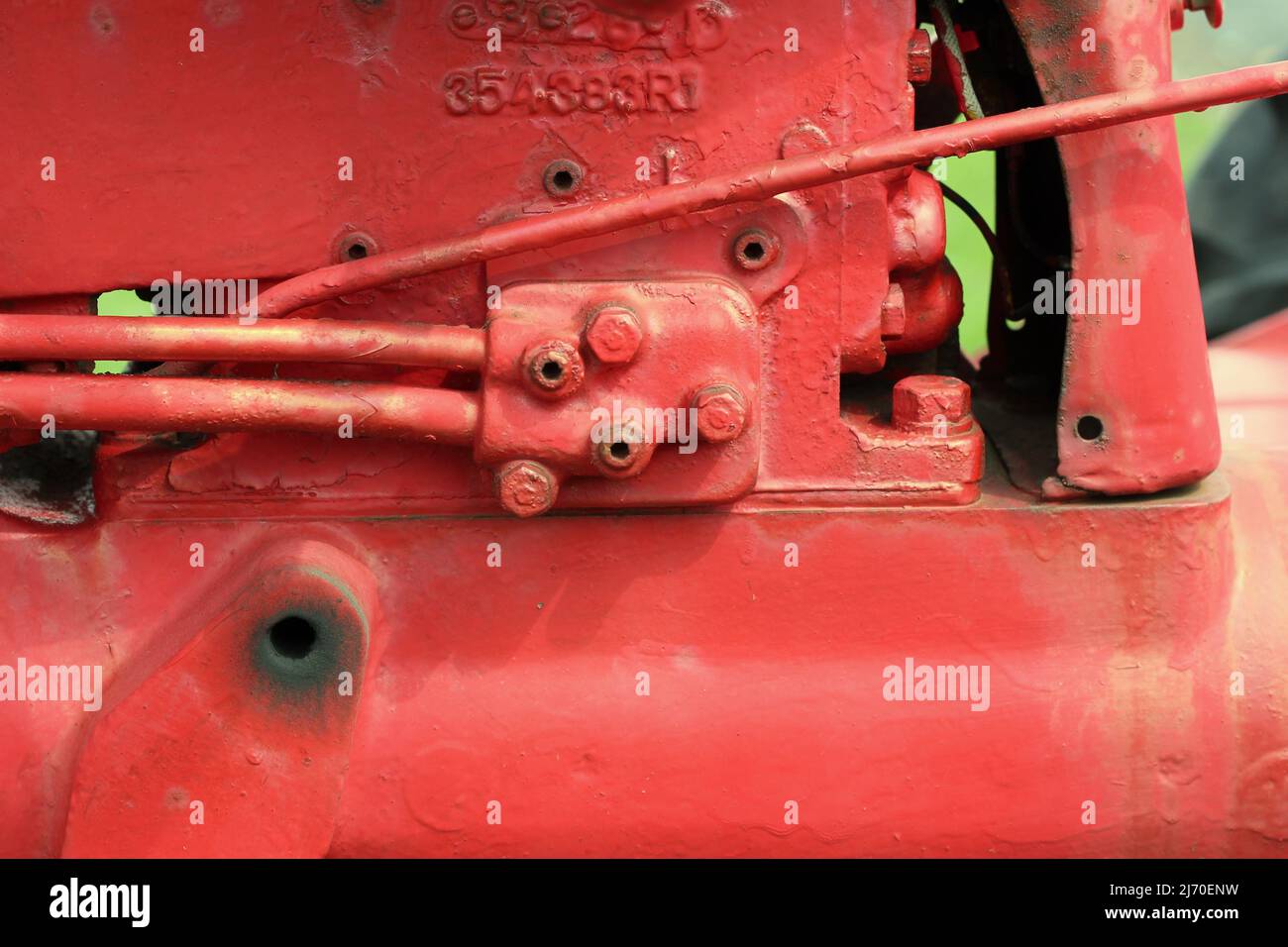 Traditional vintage bright red tractor mechanical engine and frame ...