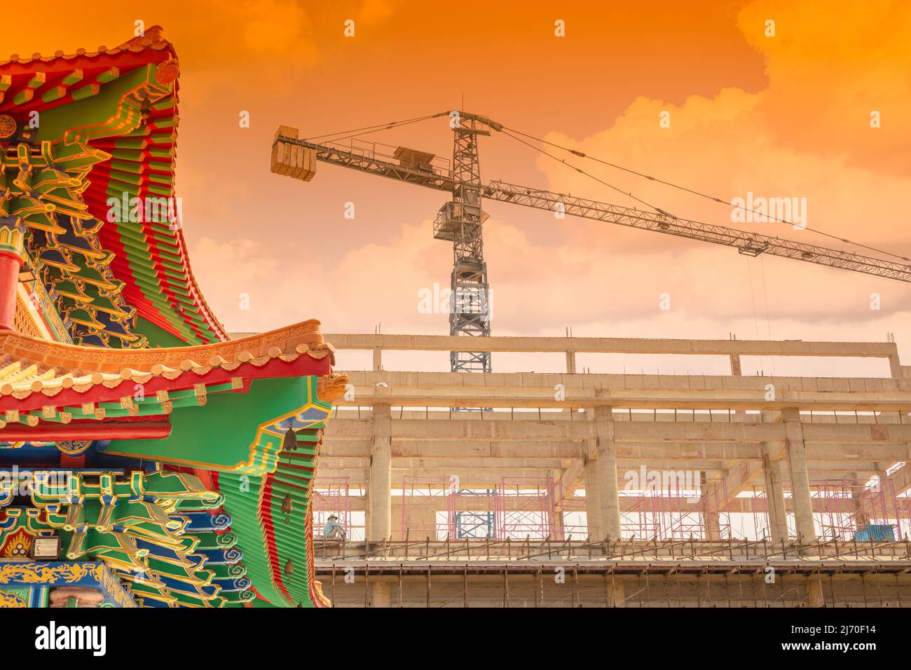 traditional Chinese building against new construction modernization of China city metro concept. Stock Photo