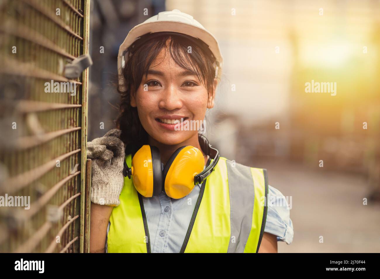 Engineer woman worker, Asian working women happy smiling in hevy industry machinery factory. Stock Photo