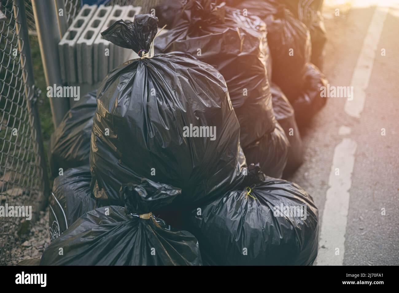 Pile of black Garbage bags. City waste management good hygiene. Stock Photo